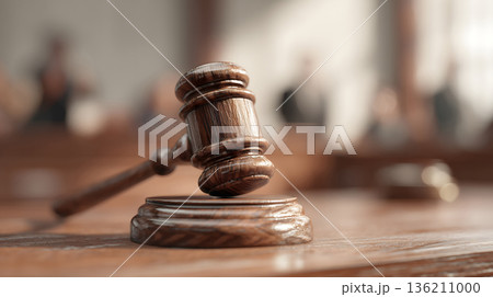 Wooden gavel sits on a wooden base. The gavel is brown and has a wooden handle 136211000