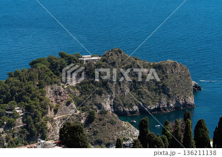 Isola Bella nature reserve near Taormina, Sicily, with rocky islet and blue Ionian Sea 136211138