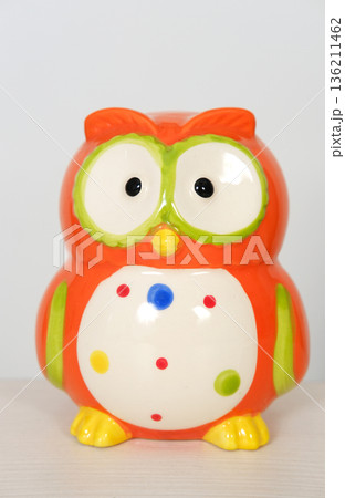 Colorful ceramic owl figurine with large eyes and polka dots, showcasing vibrant orange and green hues, perfect for home decor or as a whimsical gift idea for children 136211462