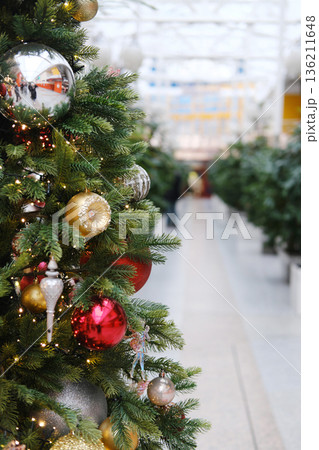 Christmas tree adorned with colorful ornaments and lights, creating a festive atmosphere, with copy space for designer use in holiday card mockup Christmas tree adorned with colorful ornaments and lights, creating a festive atmosphere, with copy space for designer use in holiday card mockup 136211648