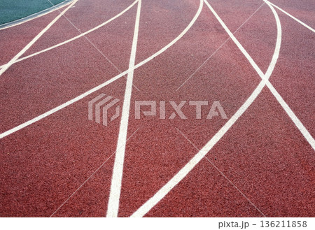 Military training ground featuring a red running track with white lane markings, designed for police and military personnel to enhance physical fitness and tactical skills Military training ground featuring a red running track with white lane markings, designed for police and military personnel to enhance physical fitness and tactical skills 136211858