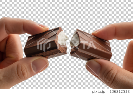 Close-up of hands breaking apart a creamy, filled chocolate bar, revealing the delicious soft center. Ideal for indulgence and food cravings Close-up of hands breaking apart a creamy, filled chocolate bar, revealing the delicious soft center. Ideal for indulgence and food cravings 136212538