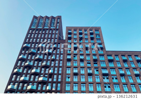 Architecture and real estate, modern residential apartment building with large panoramic windows Architecture and real estate, modern residential apartment building with large panoramic windows 136212631