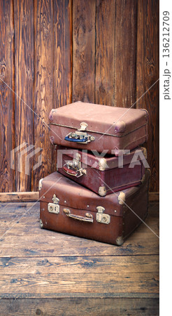 Wooden background with three suitcases Wooden background with three suitcases 136212709