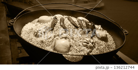 Aromatic pilaf is fried in a cauldron Aromatic pilaf is fried in a cauldron 136212744