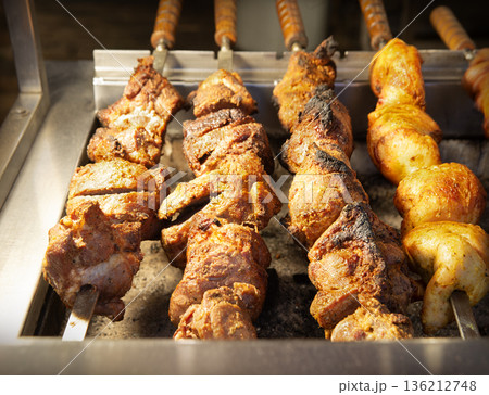A ruddy kebab is being grilled on a barbecue 136212748