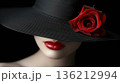 Elegant female model in retro hat with red lips and rose flower posing against a dark background 136212994