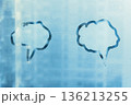 Hand drawn two blue speech bubble shape cloud for text on muddy cold glass wet window at home, copy space 136213255