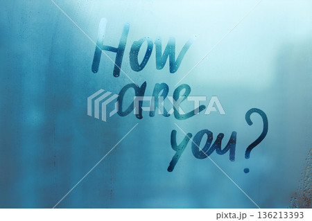 Handwritten question How are you on misted glass on window with raindrops, mental health concept 136213393