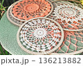 Background pink, white and gray cotton crochets dream catcher are lying on table 136213882