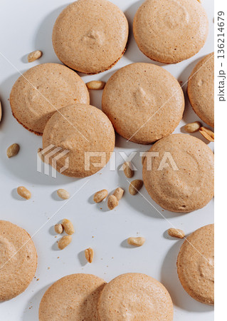 Peanut macarons flat lay on white background, minimal dessert texture Peanut macarons flat lay on white background, minimal dessert texture 136214679