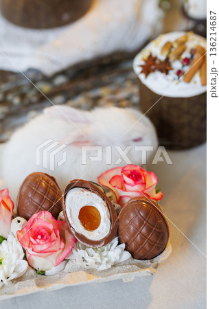 Chocolate Easter eggs with roses and white bunny, spring holiday still life 136214687