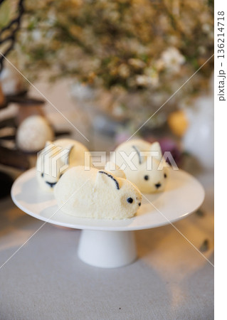 Cute bunny shaped mousse desserts on cake stand, Easter sweet treats, soft light Cute bunny shaped mousse desserts on cake stand, Easter sweet treats, soft light 136214718