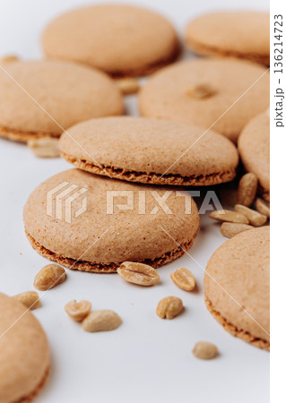 Peanut macarons flat lay on white background, minimal dessert texture 136214723
