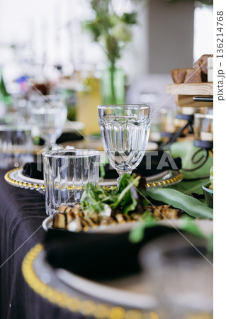Close up of elegant event table setting with glassware and appetizer 136214768