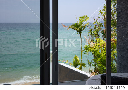 View from luxury villa at sunny day, sun loungers for sunbathing, umbrellas from the sun, pillows for swimming in the pool, palm tree on background View from luxury villa at sunny day, sun loungers for sunbathing, umbrellas from the sun, pillows for swimming in the pool, palm tree on background 136215569