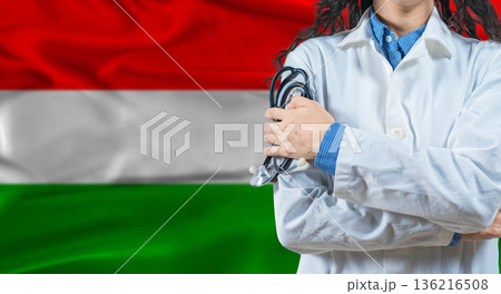 Healthcare professional with Hungary flag background. Professional doctor holding stethoscope on Hungary flag background 136216508