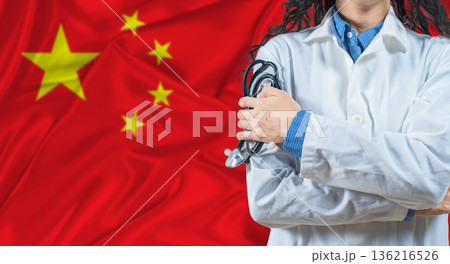 Healthcare professional with China flag background. Professional doctor holding stethoscope on China flag background Healthcare professional with China flag background. Professional doctor holding stethoscope on China flag background 136216526