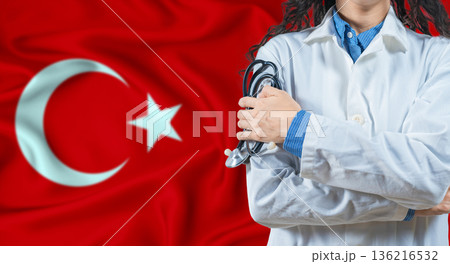 Healthcare professional with Turkey flag background. Professional doctor holding stethoscope on Turkey flag background 136216532