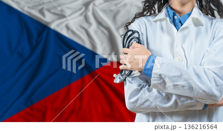 Healthcare professional with Czech Republic flag background. Professional doctor holding stethoscope on Czech Republic flag background 136216564