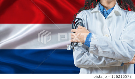 Healthcare professional with Netherlands flag background. Professional doctor holding stethoscope on Netherlands flag background Healthcare professional with Netherlands flag background. Professional doctor holding stethoscope on Netherlands flag background 136216578