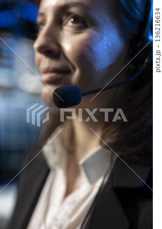 Communication with b2b clients, headset mic closeup and tech support operator in data center. Server hub worker talking in microphone during remote call, troubleshooting errors Communication with b2b clients, headset mic closeup and tech support operator in data center. Server hub worker talking in microphone during remote call, troubleshooting errors 136216634
