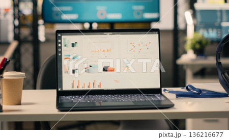 Company data shown on screen in empty executive office space, professional work environment decorated with modern furniture and office supplies. Nobody in stylish office, natural light. Company data shown on screen in empty executive office space, professional work environment decorated with modern furniture and office supplies. Nobody in stylish office, natural light. 136216677