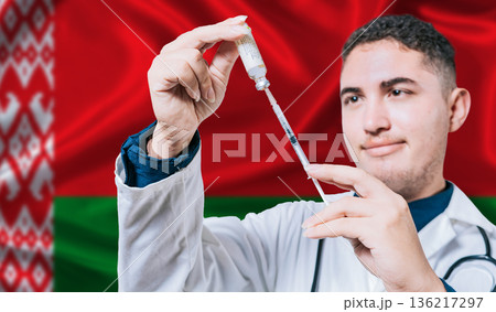 Doctor holding syringe on Belarus flag background. Medical professional holding syringe with Belarusian flag in the background 136217297