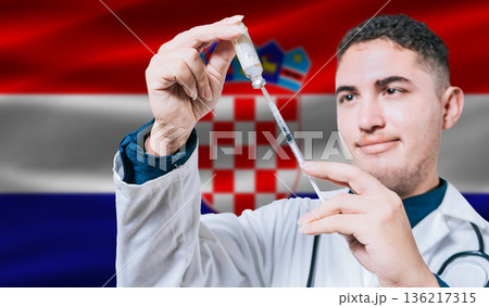 Doctor holding syringe on Croatia flag background. Medical professional holding syringe with Croatian flag in the background Doctor holding syringe on Croatia flag background. Medical professional holding syringe with Croatian flag in the background 136217315