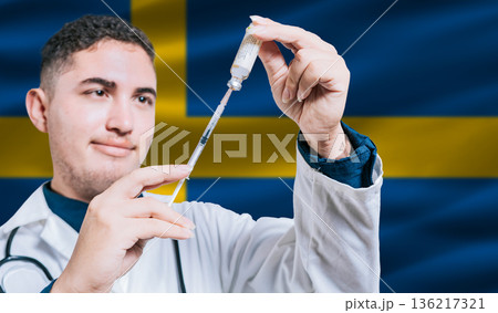 Doctor holding syringe on Sweden flag background. Medical professional holding syringe with Swedish flag in the background 136217321
