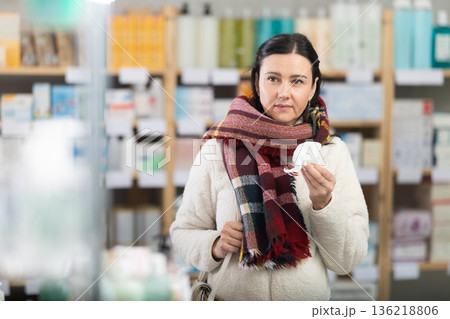 Woman visits pharmacy and suffers from sore throat Woman visits pharmacy and suffers from sore throat 136218806