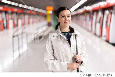 Portrait of woman at metro station waiting for train 136219163