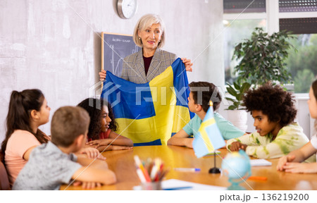 students listen to woman teacher who talks about Sweden 136219200