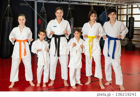 Children students repeat position and perform sequence of punches and painful techniques kata 136219241