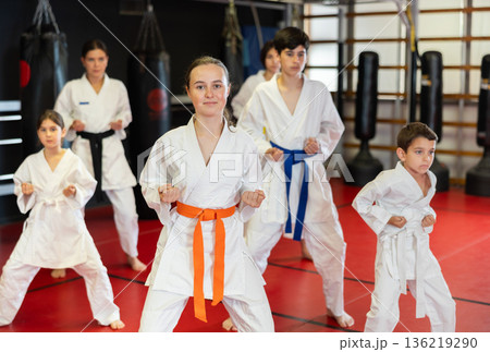 Group of children and teenagers practice karate 136219290