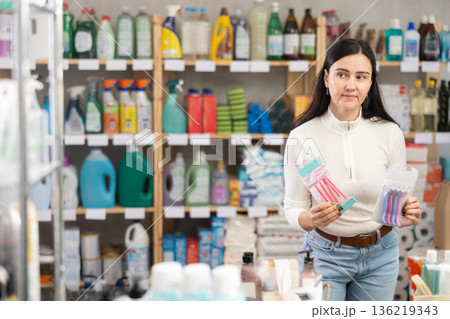 Woman choosing hair shaving machines in supermarket Woman choosing hair shaving machines in supermarket 136219343