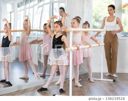 Girls in ballet class perform Batman with correction of female mentor 136219528