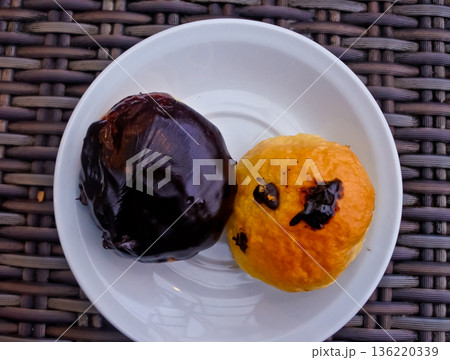 close up photo of a cup of bitter black coffee and a bread snack 136220339