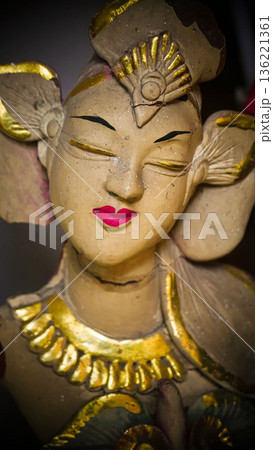 serene Bali dancer ceramic bust featuring closed eyes, bright lips, and gold embellishments. Ideal decorative sculpture for home, temple, or gallery displays, emphasizing art, culture, and craft 136221361