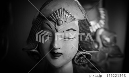 serene Bali dancer ceramic bust featuring closed eyes, bright lips, and gold embellishments. Ideal decorative sculpture for home, temple, or gallery displays, emphasizing art, culture, and craft 136221368