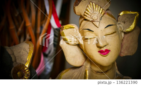serene Bali dancer ceramic bust featuring closed eyes, bright lips, and gold embellishments. Ideal decorative sculpture for home, temple, or gallery displays, emphasizing art, culture, and craft 136221390