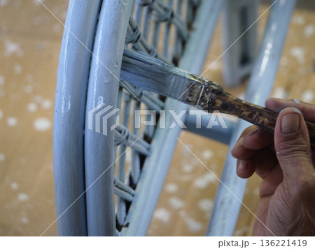 Blue paint hand brush wicker chair furniture renovation closeup home wooden floor craft blue paint hand brush wicker chair Blue paint hand brush wicker chair furniture renovation closeup home wooden floor craft blue paint hand brush wicker chair 136221419