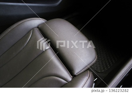 A close-up of a premium brown leather car seat with car leg rest A close-up of a premium brown leather car seat with car leg rest 136223282