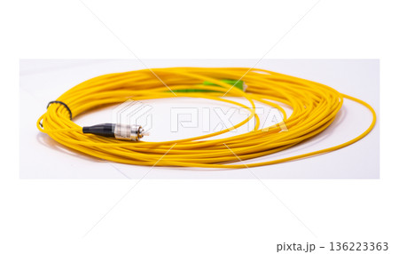 Yellow fiber optic cable rolled on white background, long network cable for data and internet connection 136223363