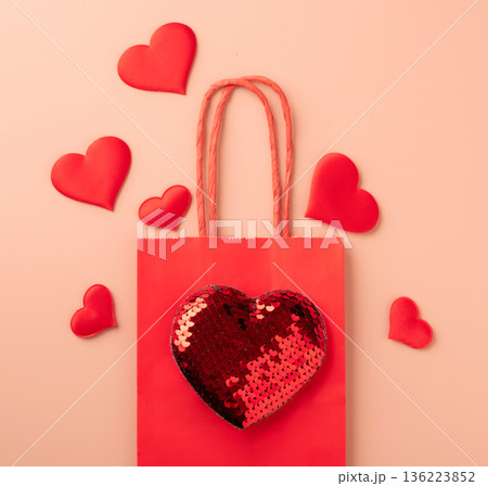 Red shopping bag on pastel background with hearts 136223852