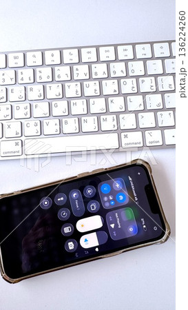 Smartphone Control Center Displayed Above Keyboard, Quick Settings For Audio And Connectivity During Remote Consultation, Tidy White Desk With Focus On Connection Smartphone Control Center Displayed Above Keyboard, Quick Settings For Audio And Connectivity During Remote Consultation, Tidy White Desk With Focus On Connection 136224260