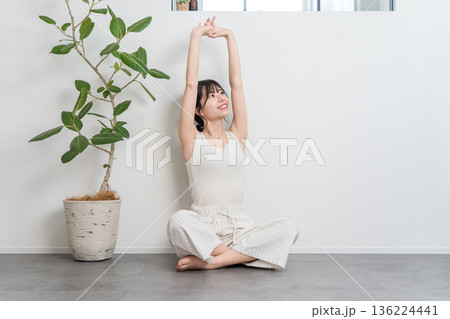 家でストレッチ・深呼吸するアジア人女性（エクササイズ,フィットネス） 136224441