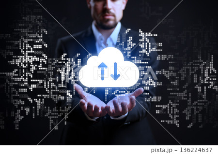 Man in business suit holds cloud symbol with data movement in a digital space Man in business suit holds cloud symbol with data movement in a digital space 136224637