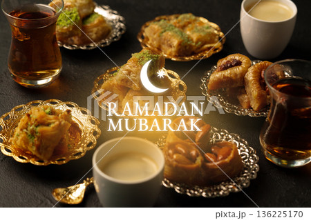Celebration of Ramadan with traditional sweets and drinks on a festive table in the evening 136225170