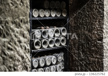 Vintage bottles stored carefully, Ancient wine containers in quiet chamber, Marbled chamber filled with aged wine bottles and cobwebs Vintage bottles stored carefully, Ancient wine containers in quiet chamber, Marbled chamber filled with aged wine bottles and cobwebs 136225762